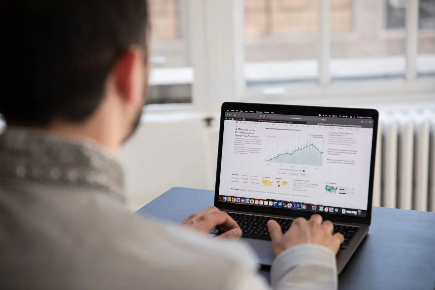 A person reviewing a sales chart on a laptop