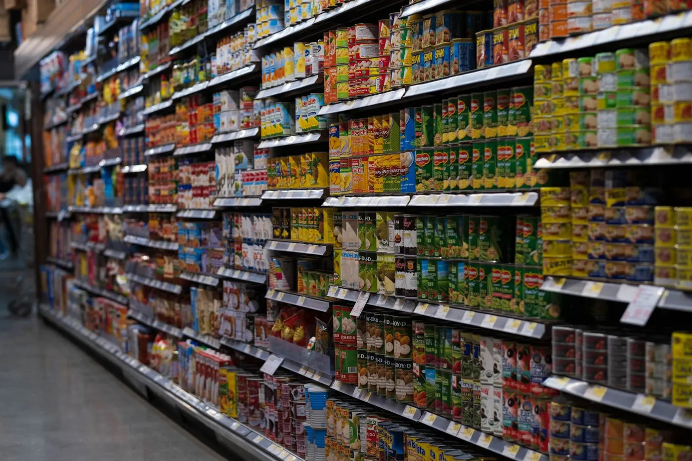 Shelves of packaged groceries in a supermarket aisle