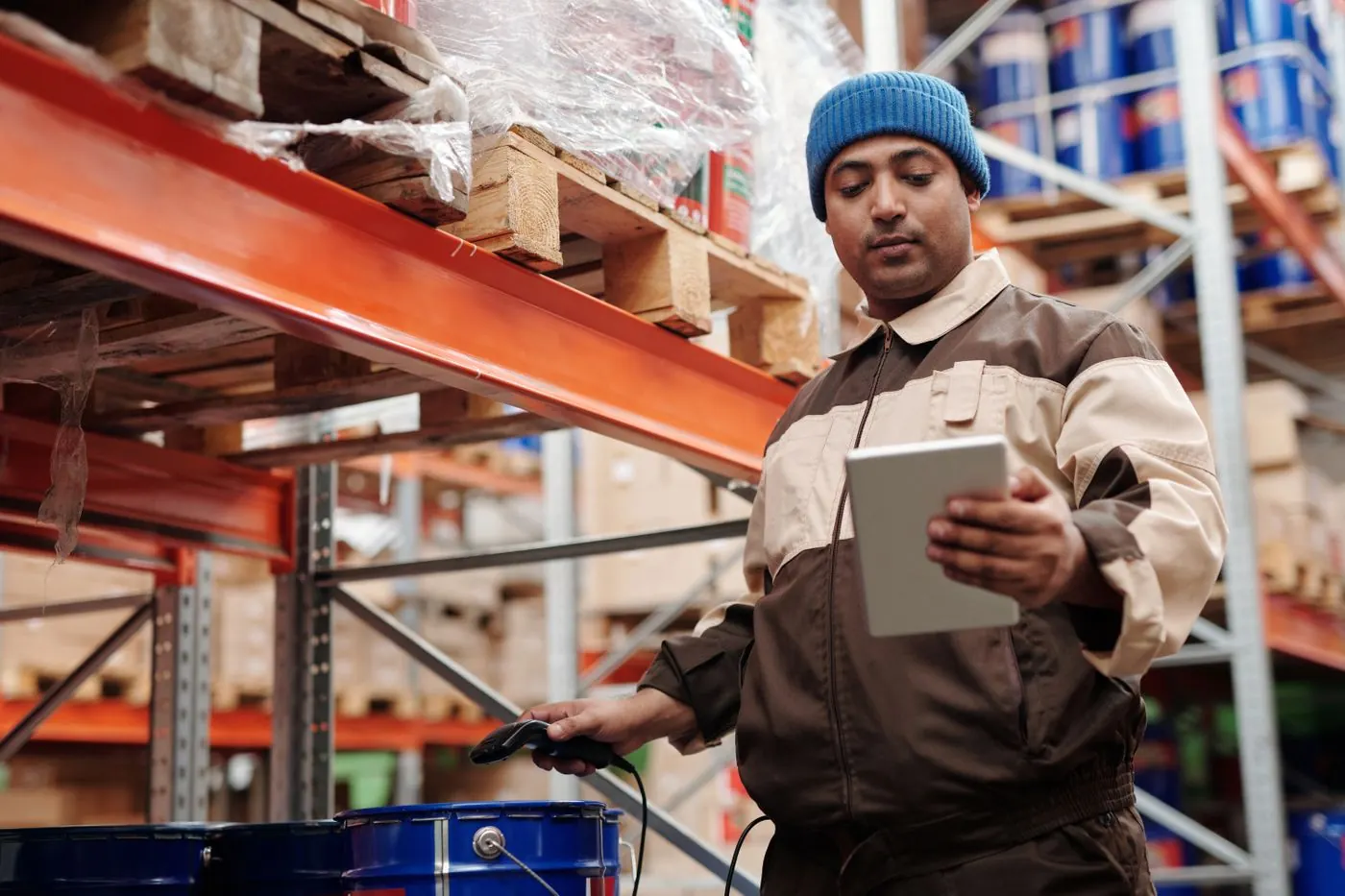 A warehouse worker checking stock on a tablet